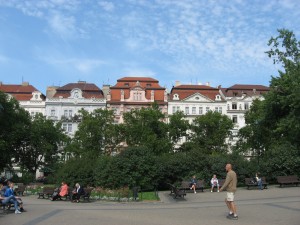 A row of four-story buildings along Namesti Miru, across from the Church of St. Ludmilla and a lovely public square